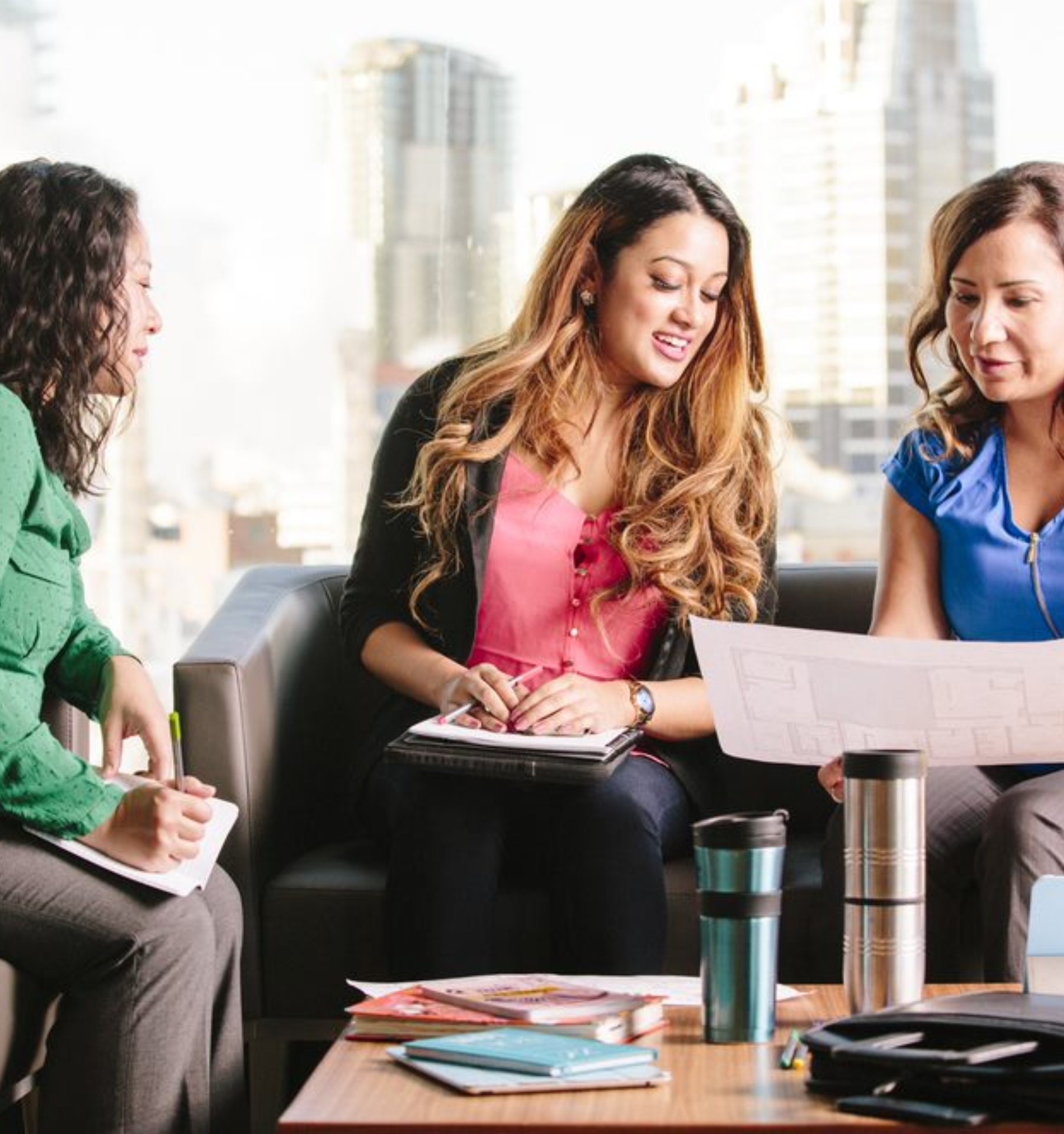 Three women in an office setting collaborating on a student placement project.