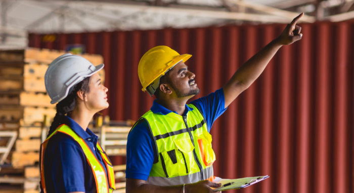 A construction student learning from her employer.